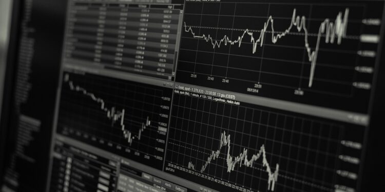 Siyah arka planda finansal grafikler ve hisse senedi piyasası verileri.